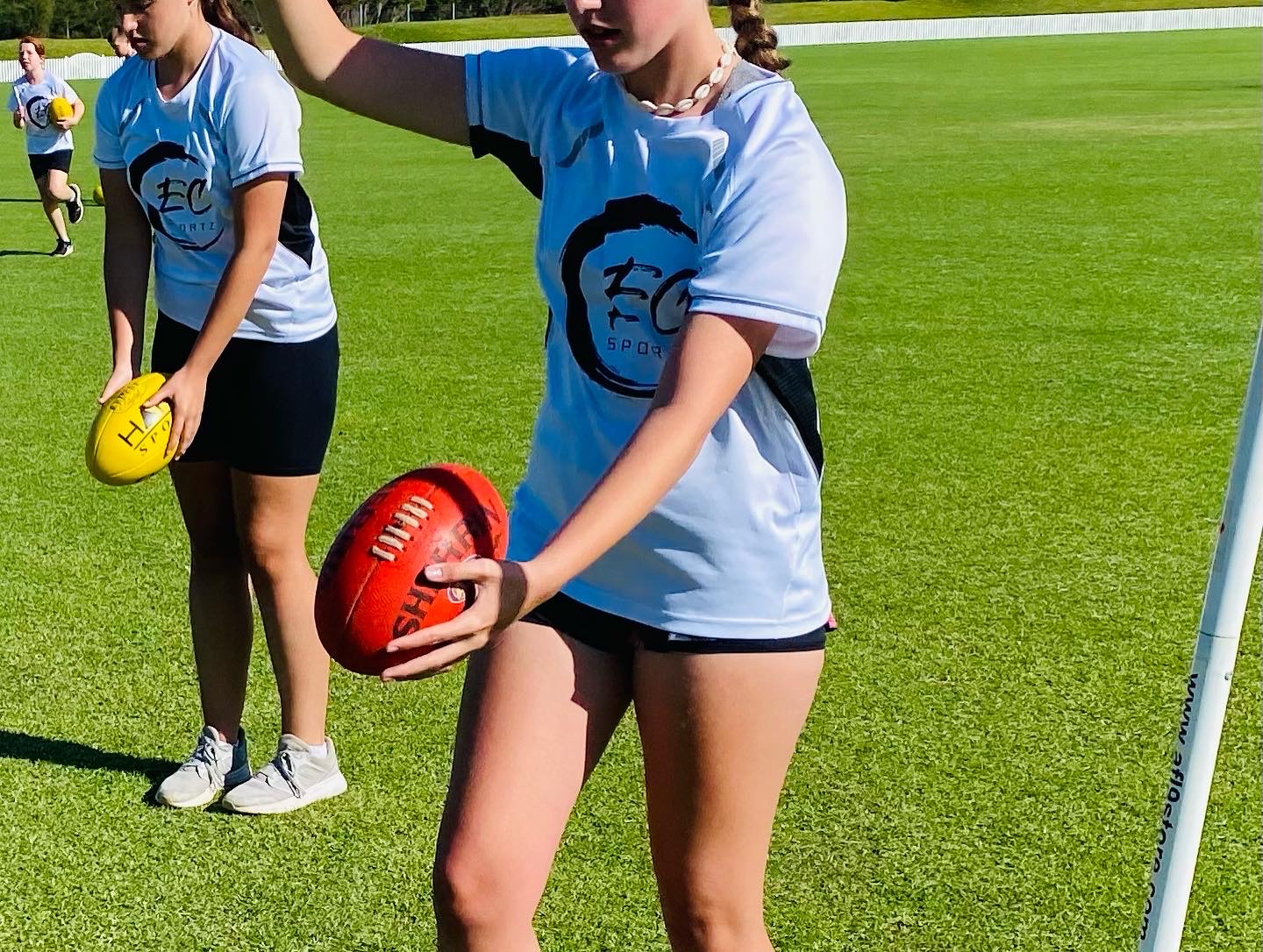 EC Sportz Academy players developing AFL ball-handling technique